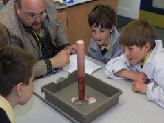 Andy and some of the children observing the simulated innards of an erupting volcano